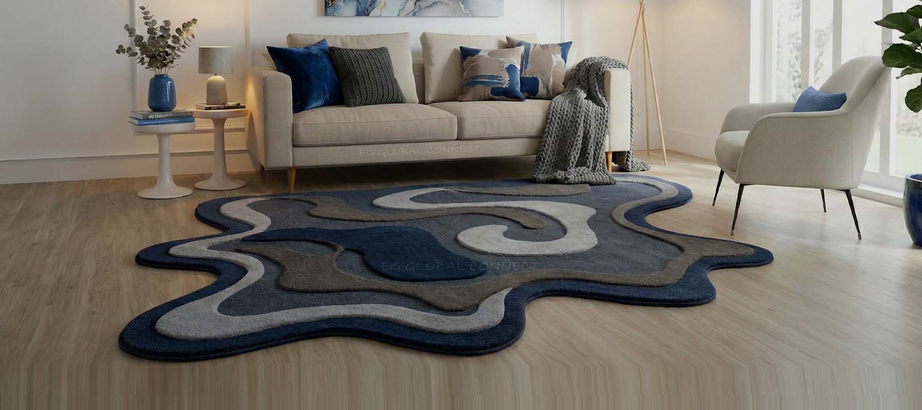 Abstract hand-tufted wool rug in blue and grey organic shapes placed in a modern living room interior